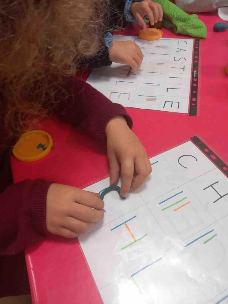french preschool_child writing_the knowledge nuggets